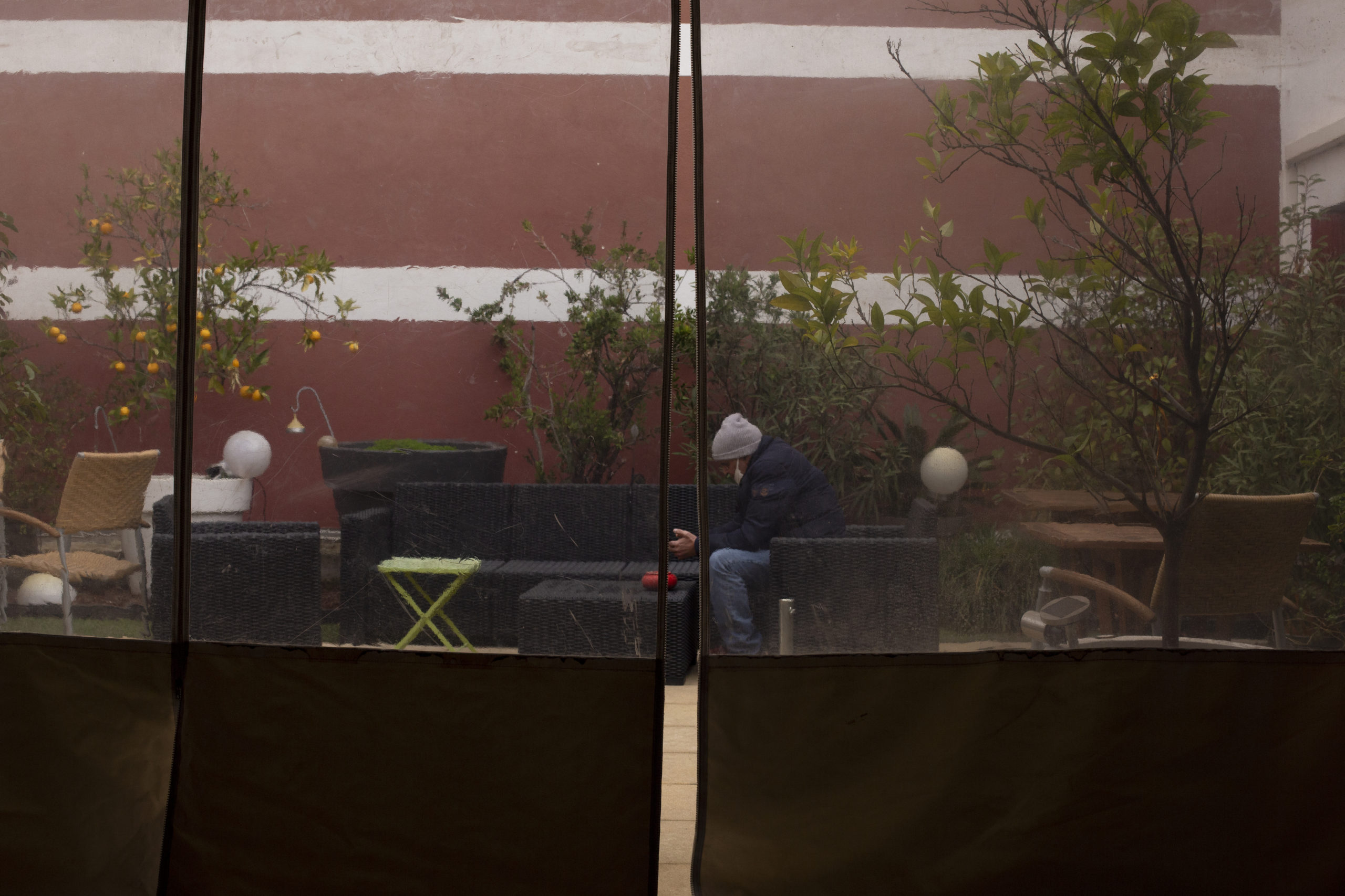 A man is sitting in a patio